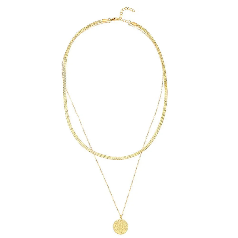 Doppelte goldene Halskette mit rundem, strukturiertem Anhänger auf weißem Hintergrund