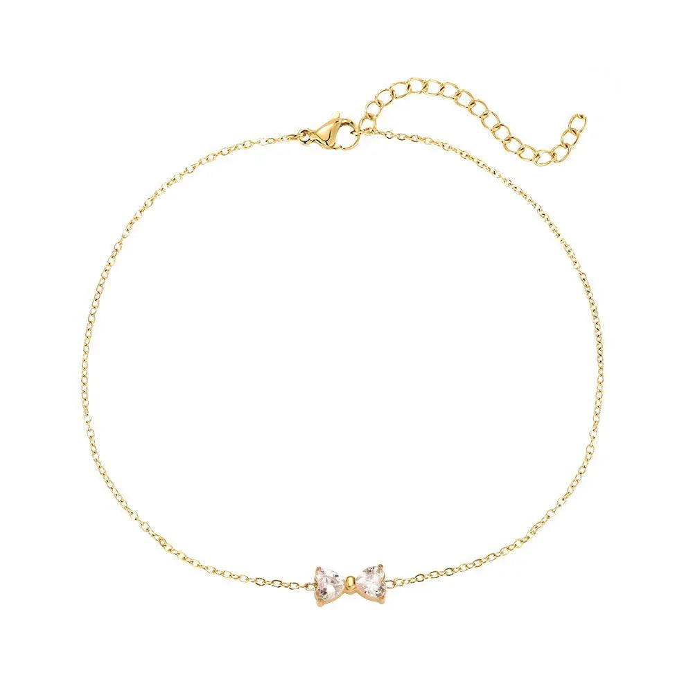 Feines goldfarbenes Armband mit zartem Schleifenanhänger und Verlängerungskette